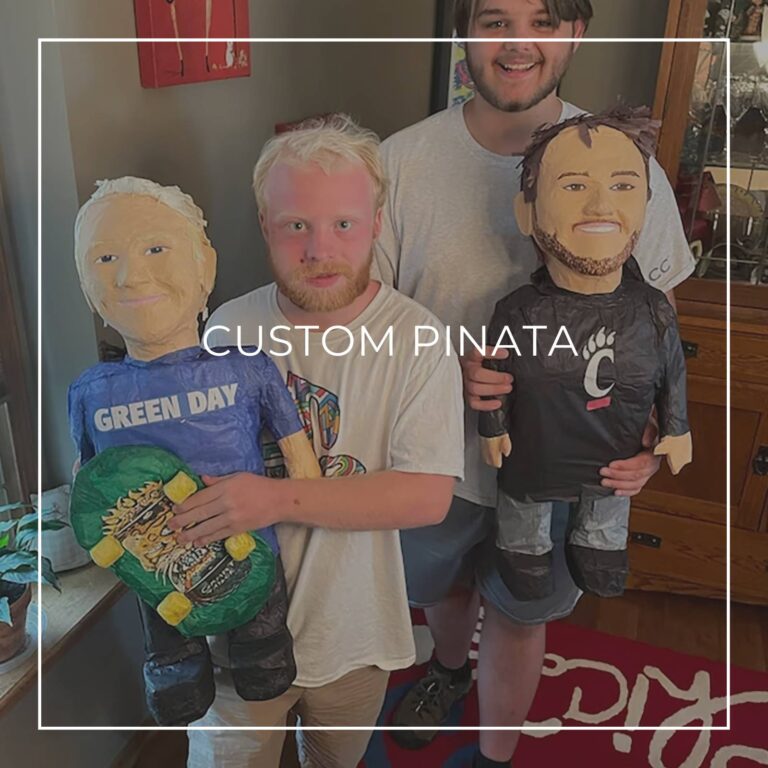 man standing next to a custom pinata of himself