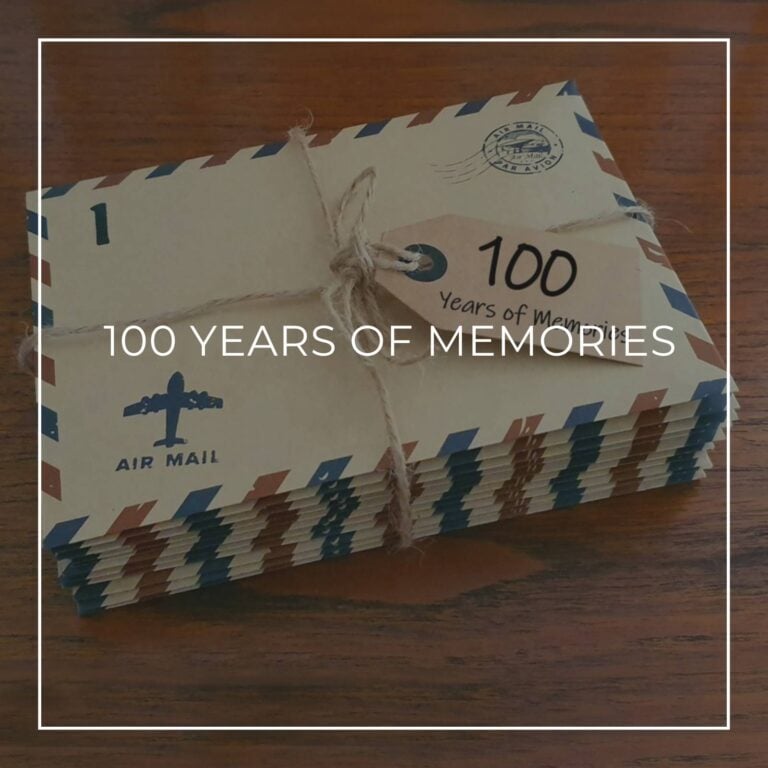 a stack of numbered '100 years of memory' letters in air mail envelopes