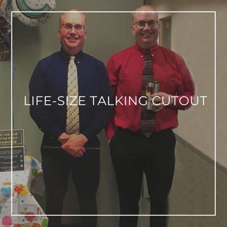 50 year old man standing next to a life-size cutout standee of himself