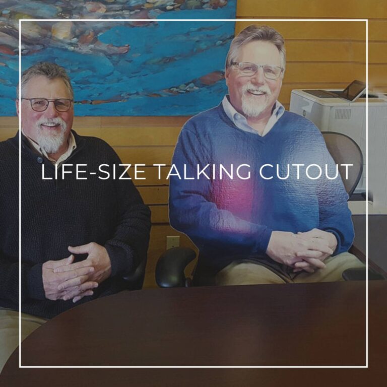 child standing between a life-size cutout standee of his father and grandfather