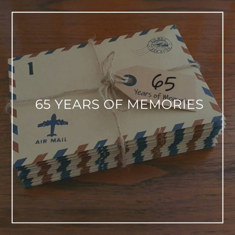 a stack of numbered '65 years of memory' letters in air mail envelopes