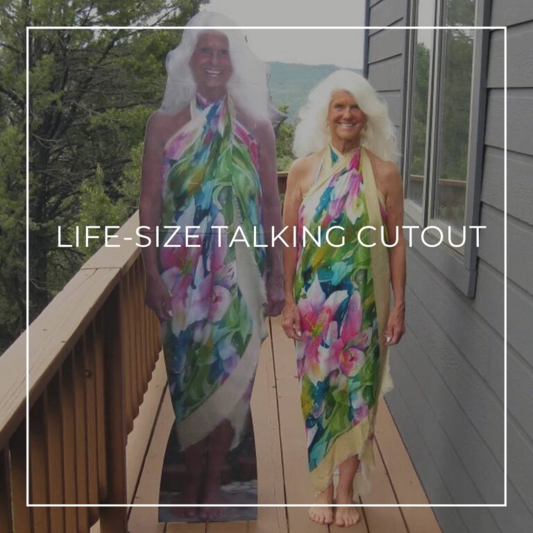 75 year old woman standing next to a life-size cutout standee of herself