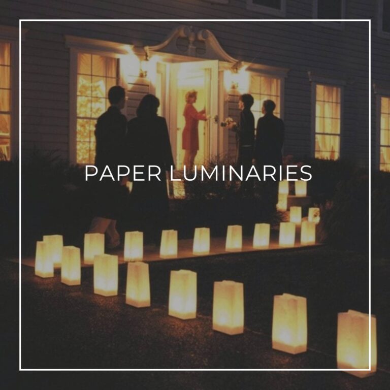 guests arriving at a 80th birthday party at home with a pathway to the front door lined with paper luminaries