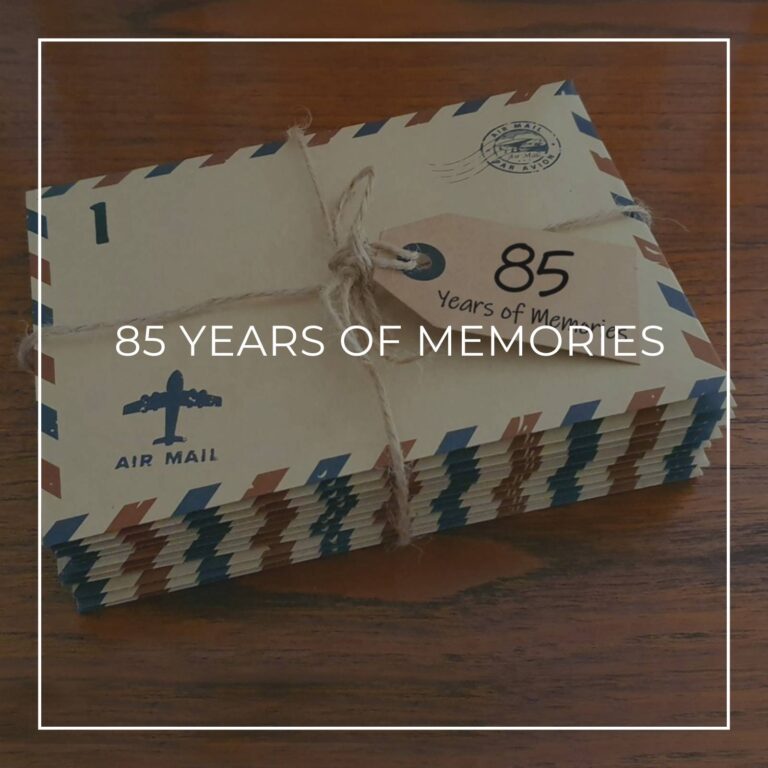 a stack of numbered '85 years of memory' letters in air mail envelopes