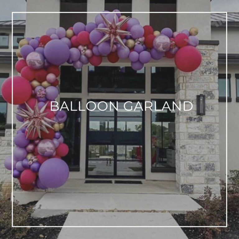 red and purple balloon garland decoratings draped around entrance doors to a house