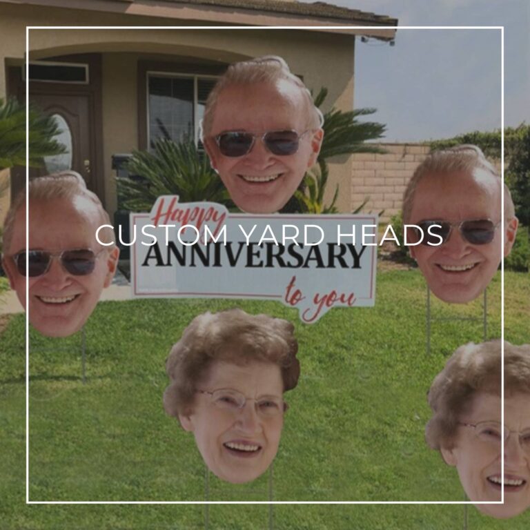 custom photo yard heads of a senior couple's faces arranged on a front lawn outside a house