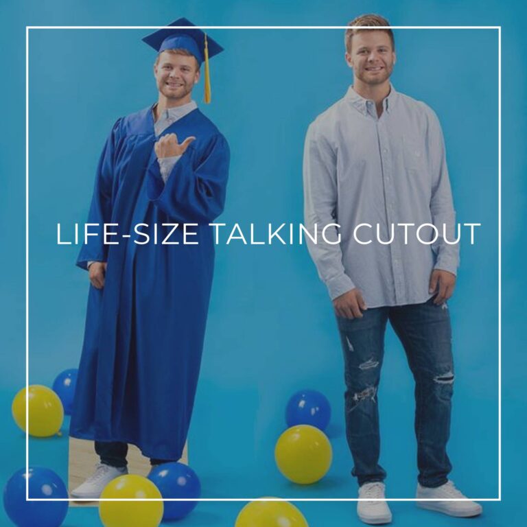 man standing next to a life-size cutout standee of himself in a graduation robe and cap