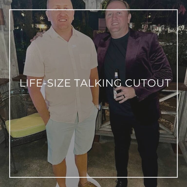 man in a suit standing next to a life-size cutout standee of himself