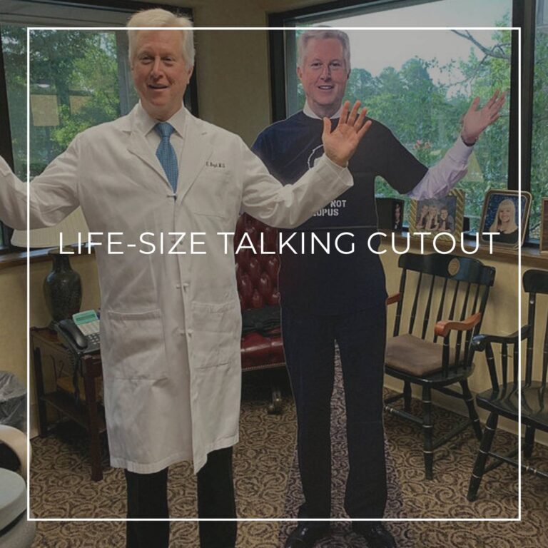 doctor standing next to a life-size cutout standee of himself