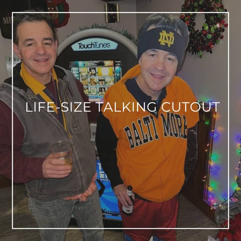 man in a suit standing next to a life-size cutout standee of himself