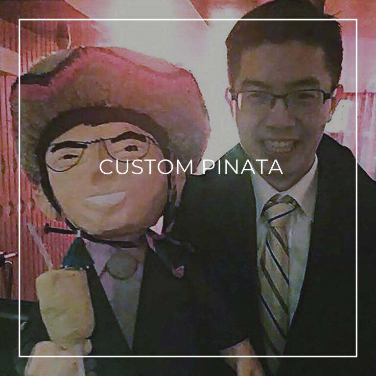 man standing next to a custom pinata of himself