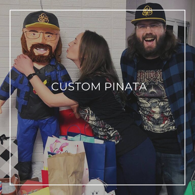 man standing next to a custom pinata of himself