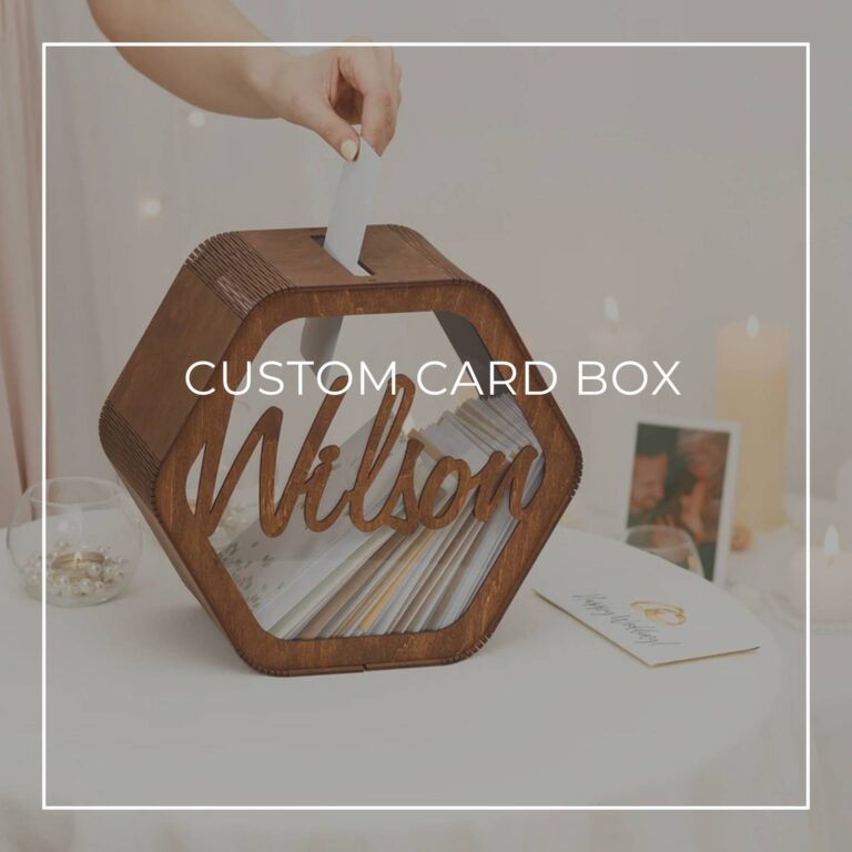 woman's hand placing a card into a custom wood card box with the name Wilson on it