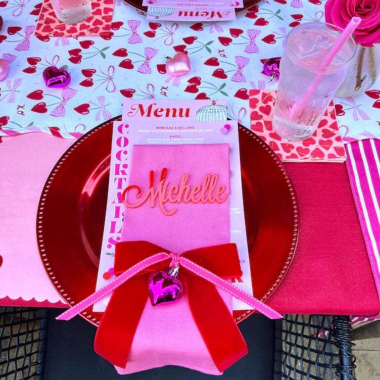 Coral 3D script name Michelle on a pink napkin with red bow at a heart-print Valentine table