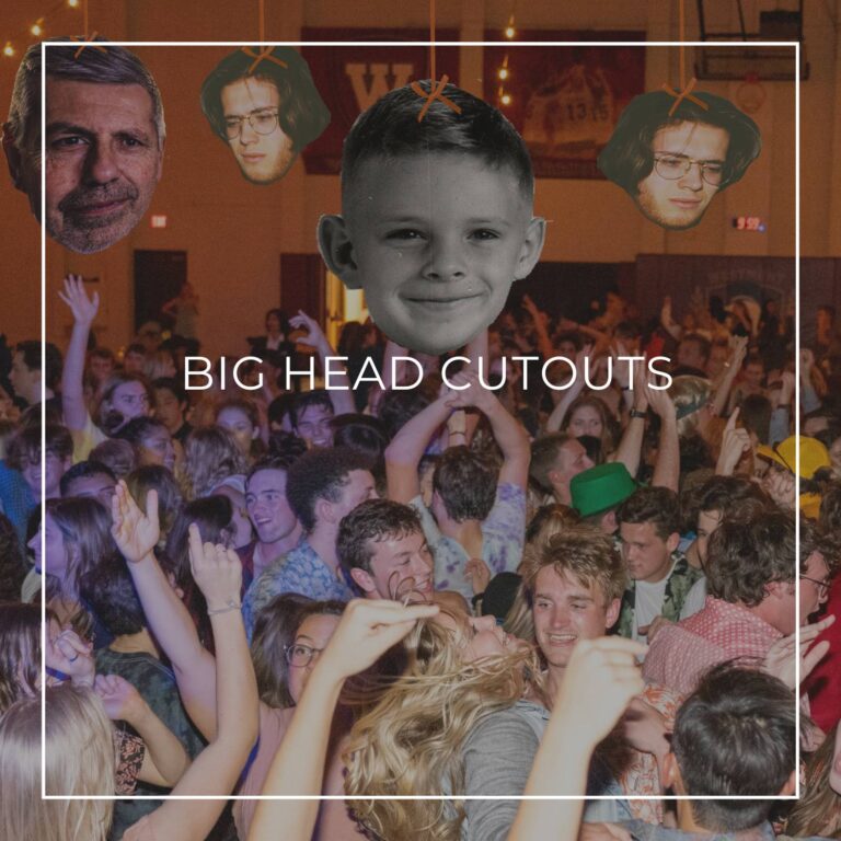 giant custom face cutouts showing the 50th birthday boy at different ages used as hanging decorations above a crowd of dancing party guests