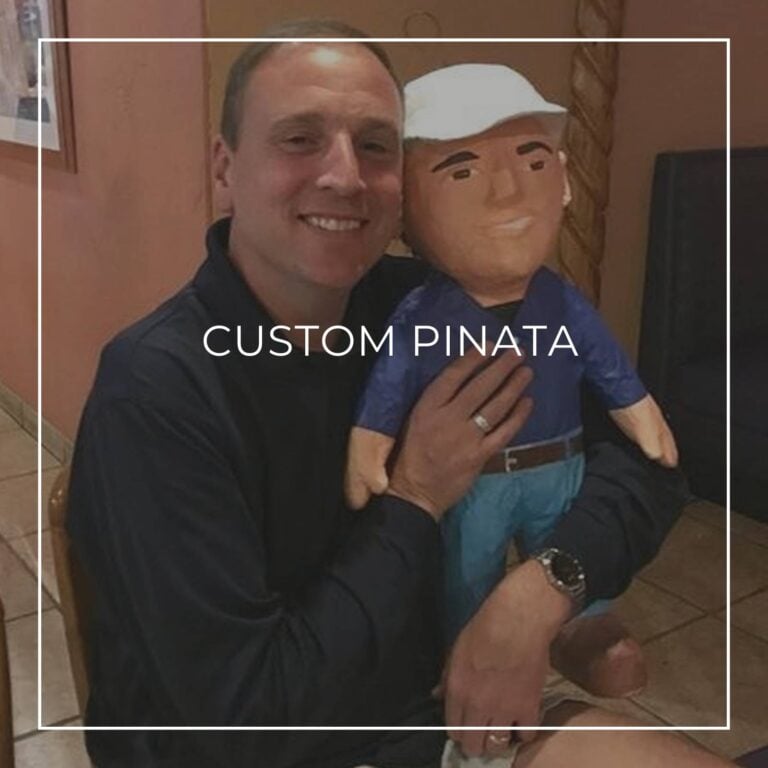 man standing next to a custom pinata of himself
