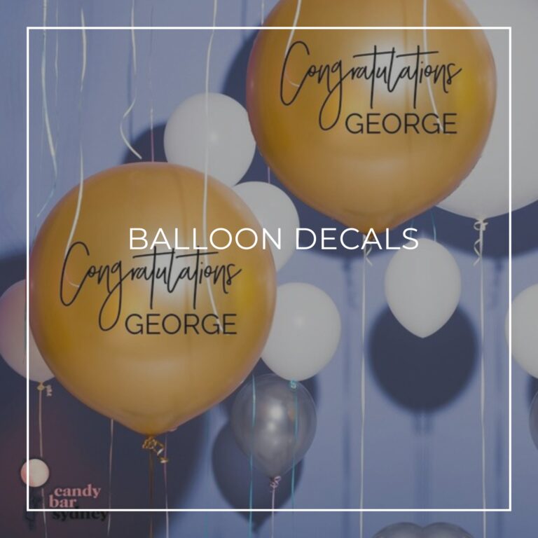 'Congratulations George' custom name balloon decals applied to gold balloons for a 65th birthday party