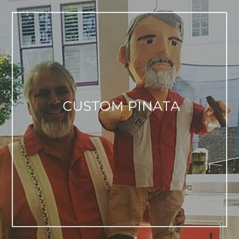 man standing next to a custom pinata of himself