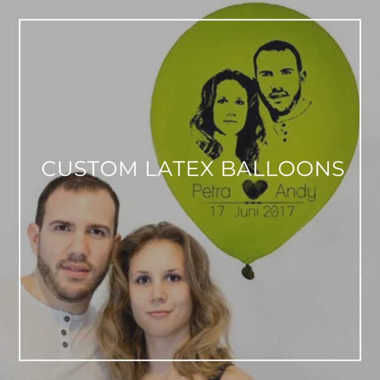 couple standing next to a green custom printed balloon with their faces on