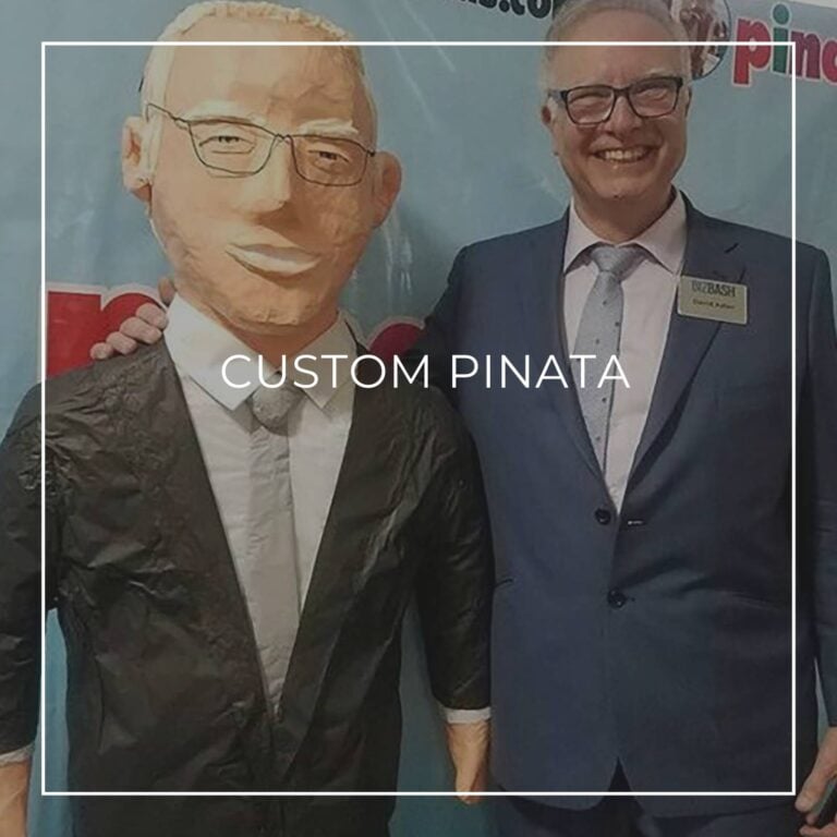 man standing next to a custom pinata of himself