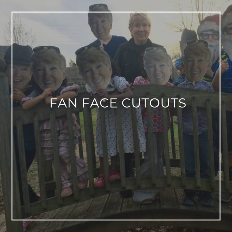 group of people and kids holding custom fan faces of the 75th birthday girl in front of their own faces