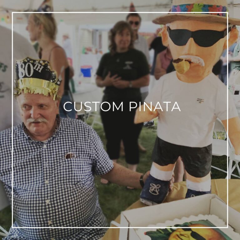 man standing next to a custom pinata of himself