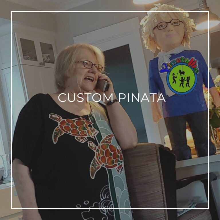 man standing next to a custom pinata of himself