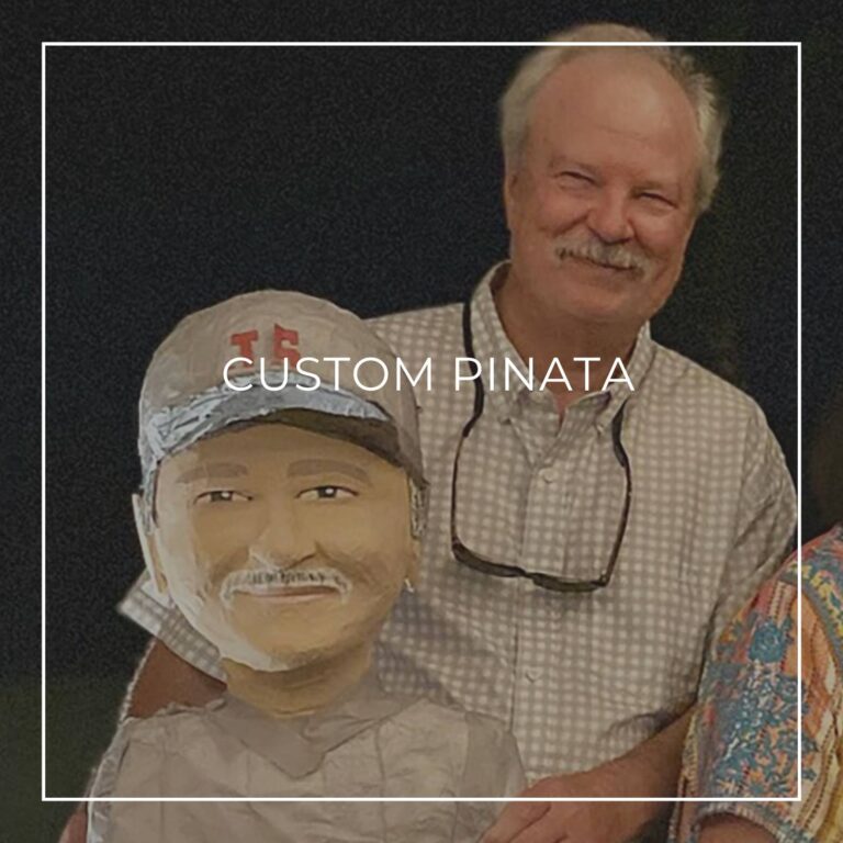 man standing next to a custom pinata of himself