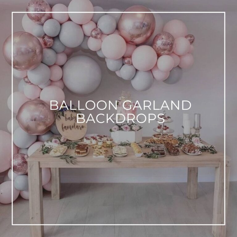 pink, white, and gray balloon garland surrounding a party dessert table