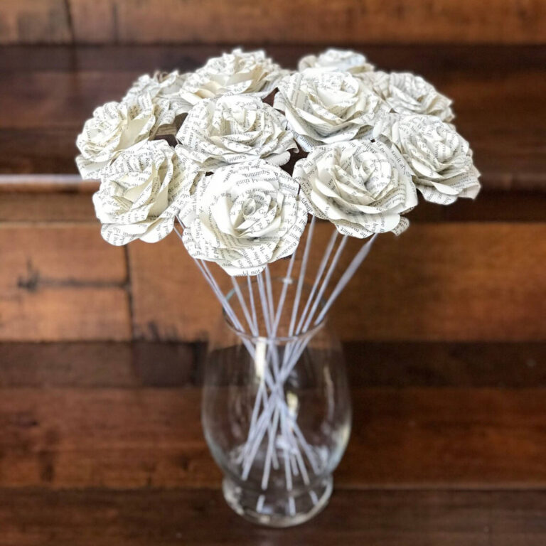 Bouquet of book-page paper roses on wire stems displayed in a glass vase