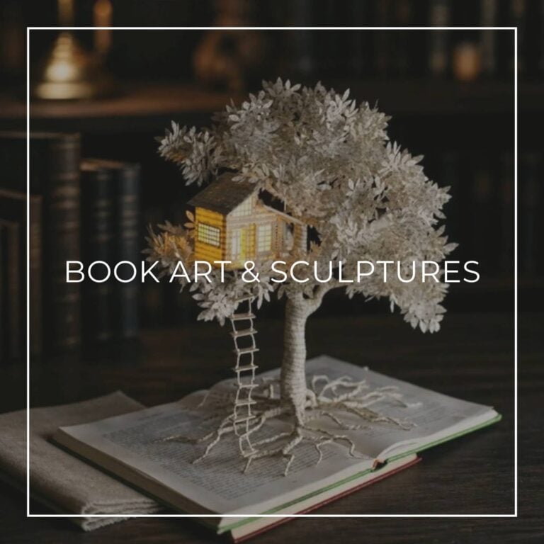 Book art sculpture of a paper tree with a glowing miniature treehouse growing from an open book