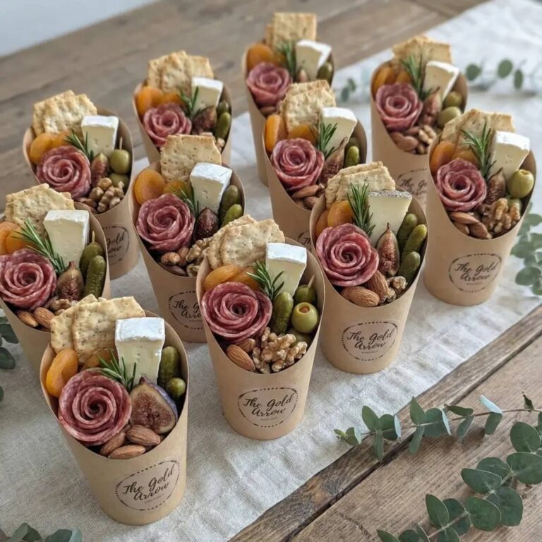 Individual charcuterie cups with meat and cheese for a party buffet