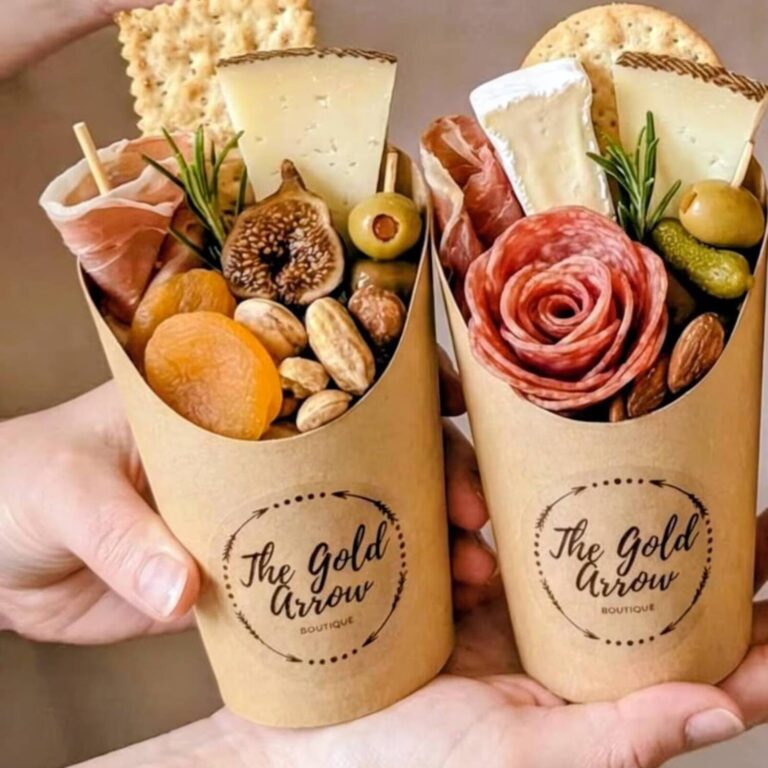 Individual charcuterie cups arranged on a buffet table