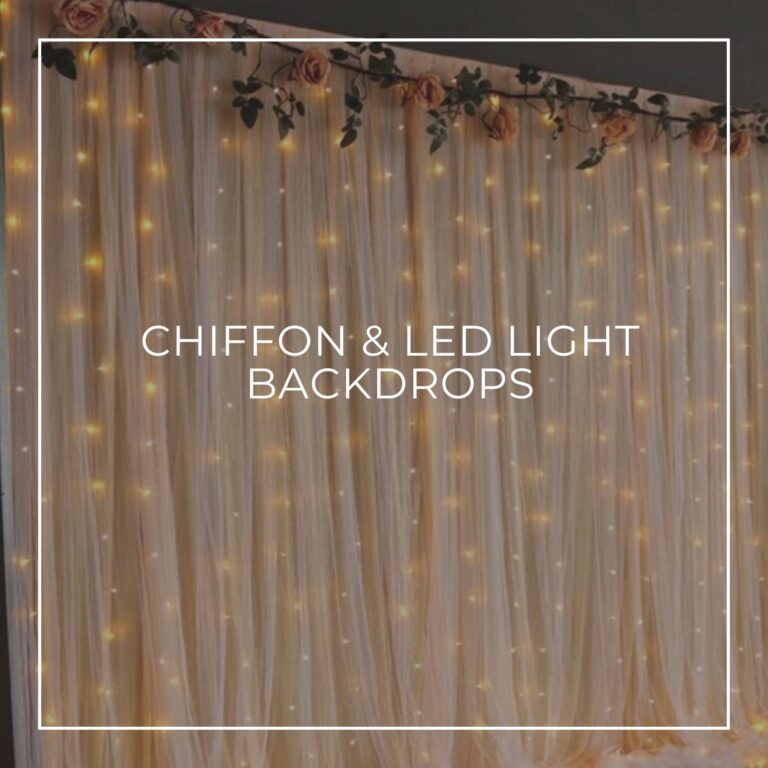 cream chiffon fabric party backdrop back-lit with yellow LED string lights and dressed with flowers