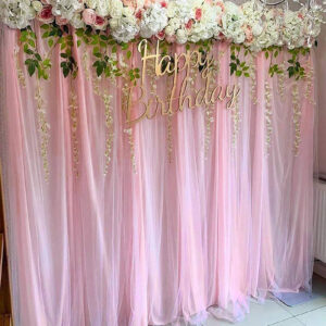 pink and white chiffon tulle fabric party backdrop for a birthday party