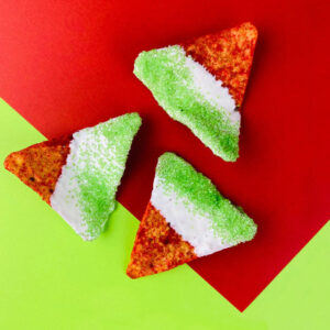 white chocolate dipped hot Doritos with green sprinkles
