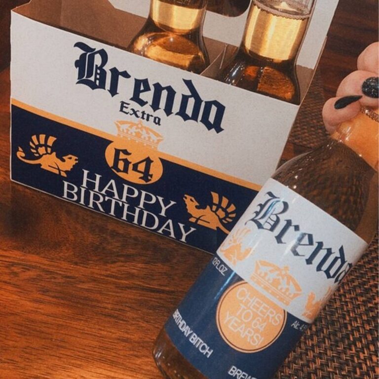Beer six-pack with a navy and gold "Brenda Extra, 64, Happy Birthday" label, bottle in front reading "Cheers to 64 Years, Birthday Bitch"