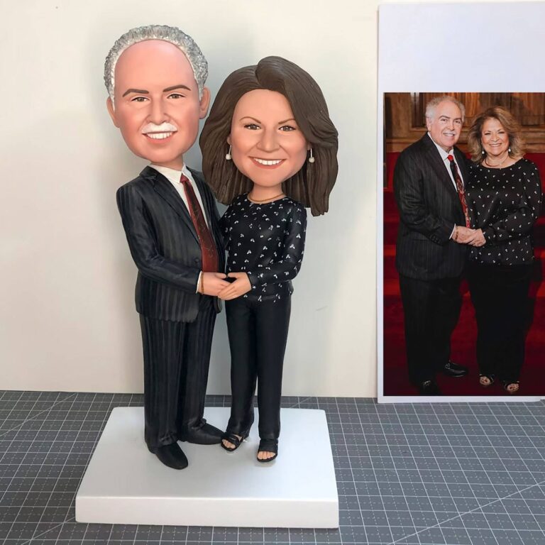Custom couple bobblehead of an older man in a pinstripe suit and woman in a black floral top