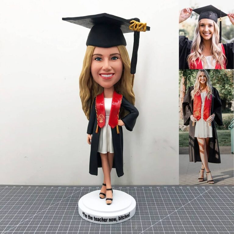 Custom graduation bobblehead with cap, gown and red stole, base reads “I’m the teacher now, bitches!”