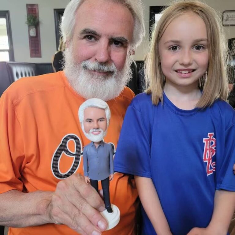 Custom bobblehead of a white-bearded grandfather, held next to his granddaughter