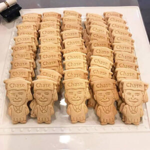 personalized custom caricature cookie of a young man in a graduation cap and gown for a graduation party