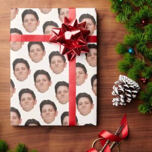 gift wrapped with custom face photo gift wrap of a young mans face repeated many times