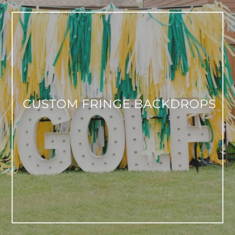 green, yellow, and white custom fringe party backdrop with marquee letters spelling GOLF in a backyard