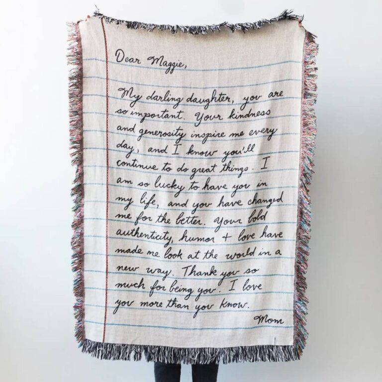 Woven blanket with a handwritten letter to ‘Dear Maggie’ signed by Mom, in notebook-paper design