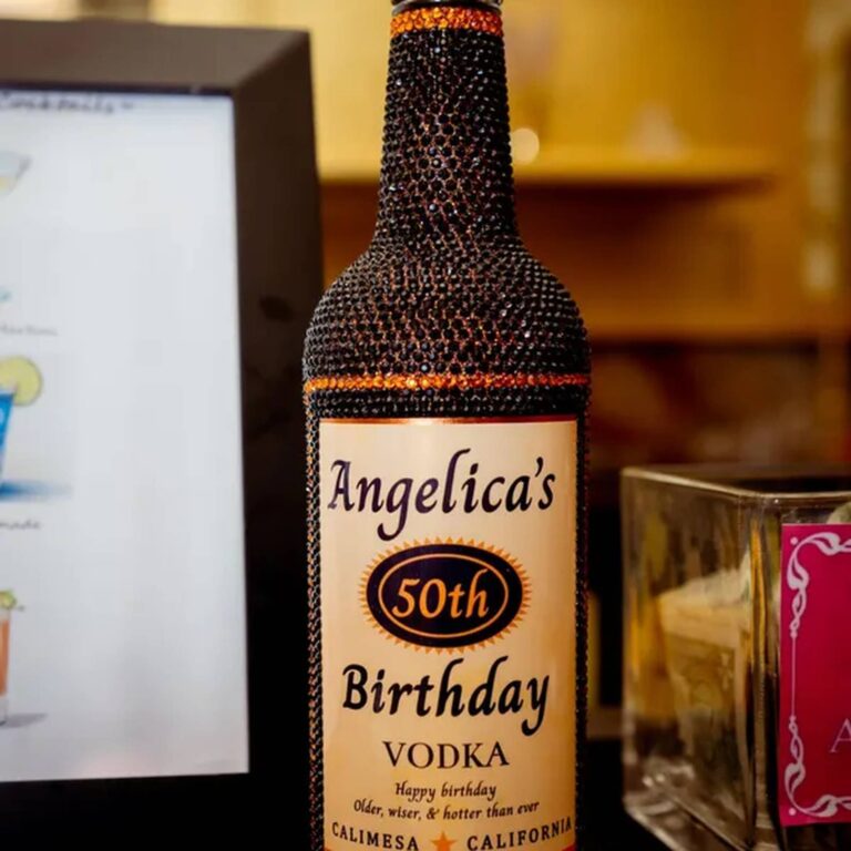 Rhinestone-covered bottle with an "Angelica’s 50th Birthday Vodka, Calimesa California" label