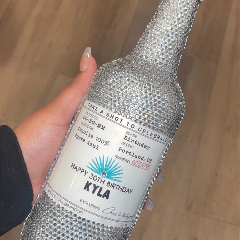 Rhinestone-covered tequila bottle held in hand with a "Take a Shot to Celebrate, Happy 30th Birthday, Kyla" label