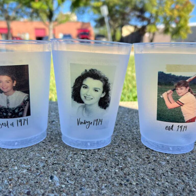 Three frosted photo cups on pavement outdoors, printed with three different women’s throwback photos reading “...est of 1974,” “Vintage 1974,” and “est. 1974”