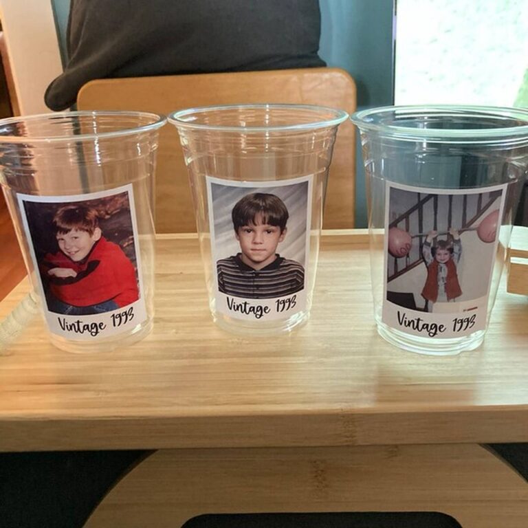 Three clear photo cups on a wood table, each printed with a different child’s photo and “Vintage 1993”