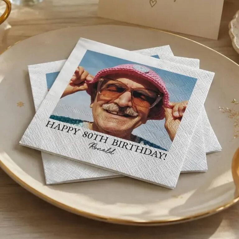 “Celebrating 90 Years, Charlie Atkinson” napkin with three photos spanning military service to present day