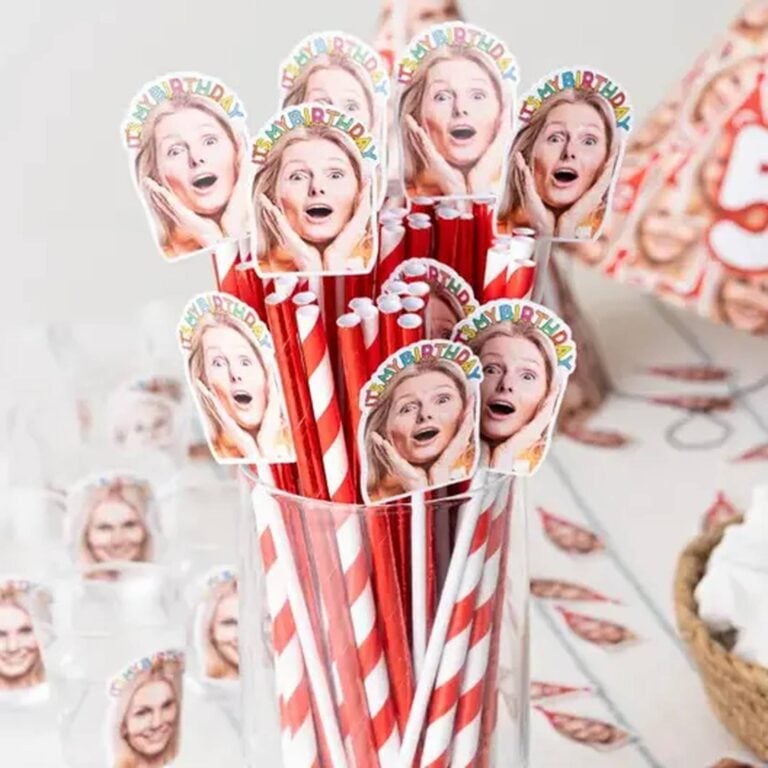 Red-and-white striped photo straws topped with a woman’s shocked face and “It’s My Birthday” text, several repeated in a cup